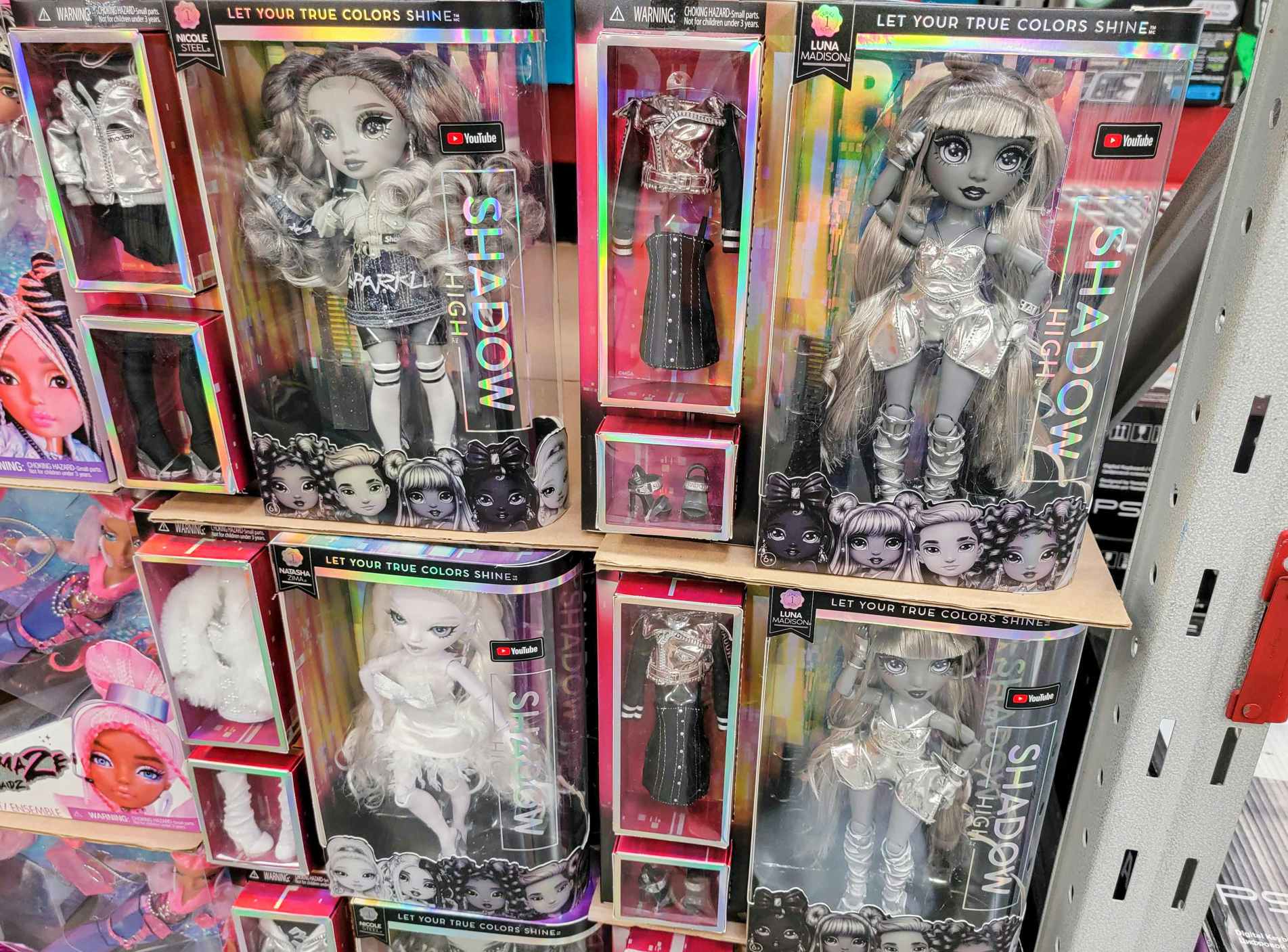 a display of various rainbow high shadow high dolls