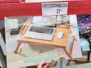 hand holding a box with a wooden media tray in it