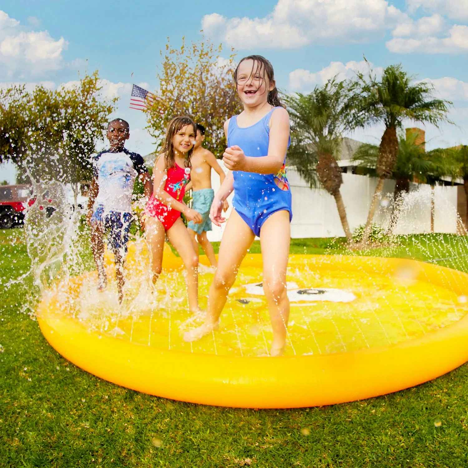 kids playing in a yellow blowfish splash pad