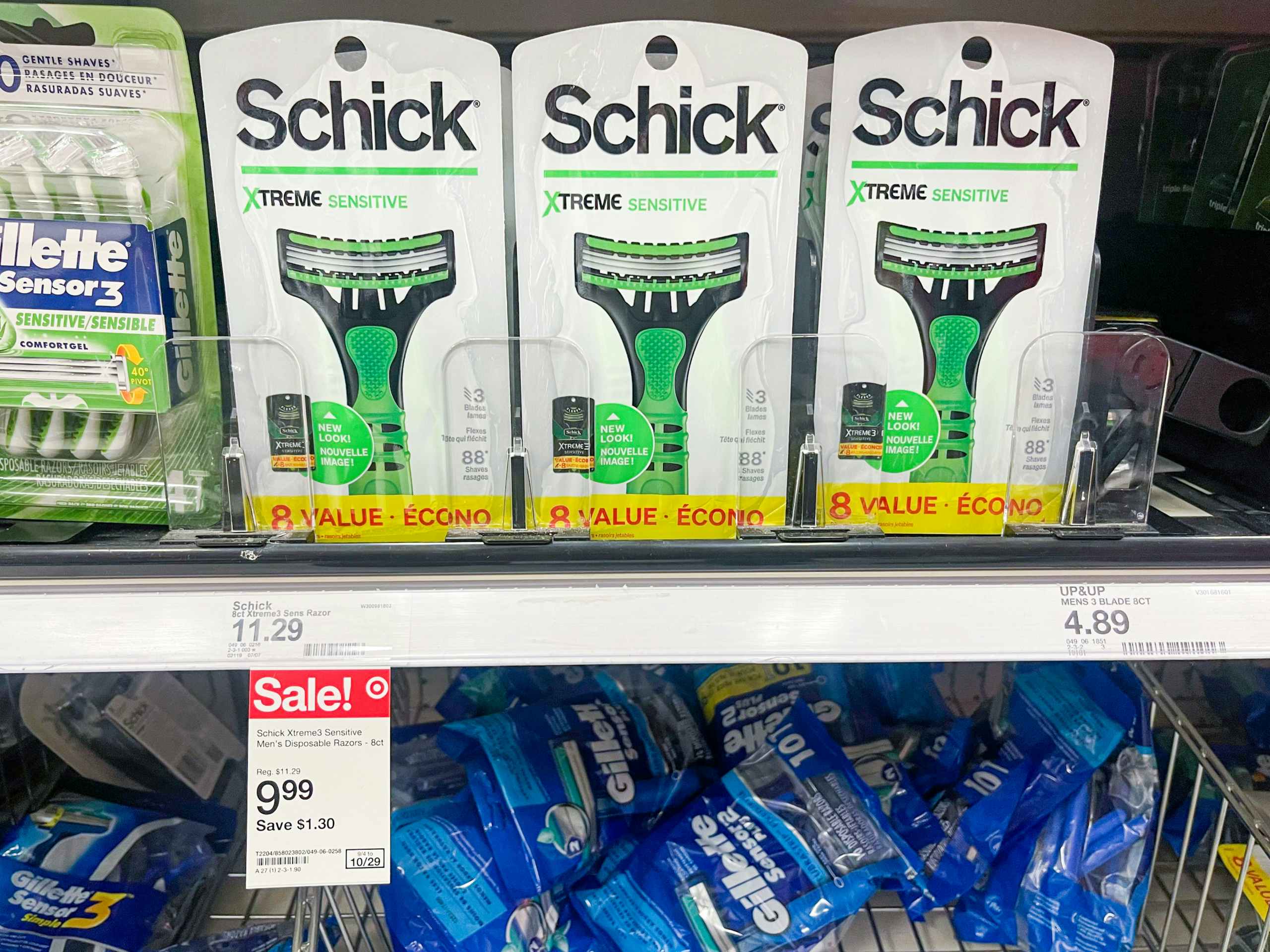 Schick Extreme Sensitive razors sitting on a store shelf with a Sale sticker underneath them.