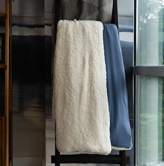 a blue and white weighted sherpa blanket