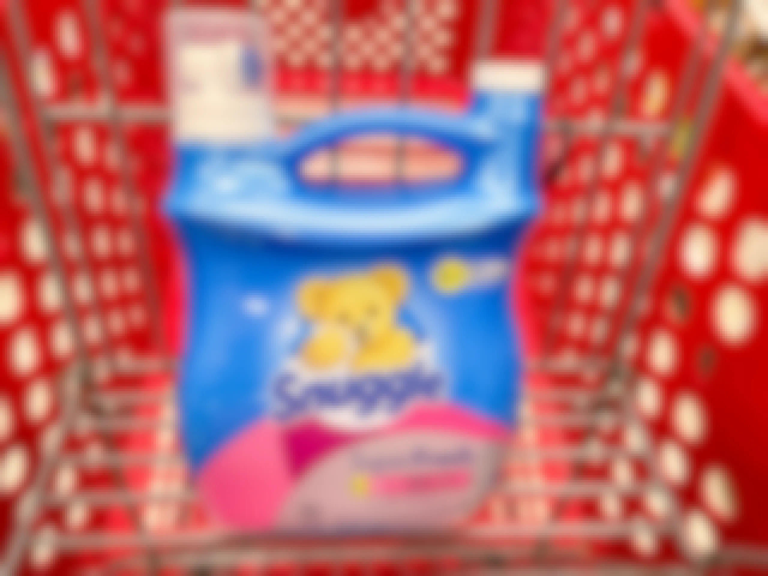 A jug of Snuggle Super fresh fabric softener sitting in a shopping cart.