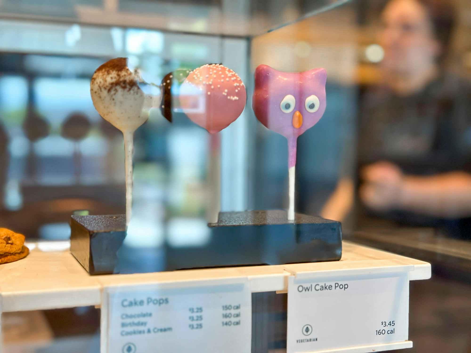 the food display case at Starbucks with an owl cake pop from the new fall menu