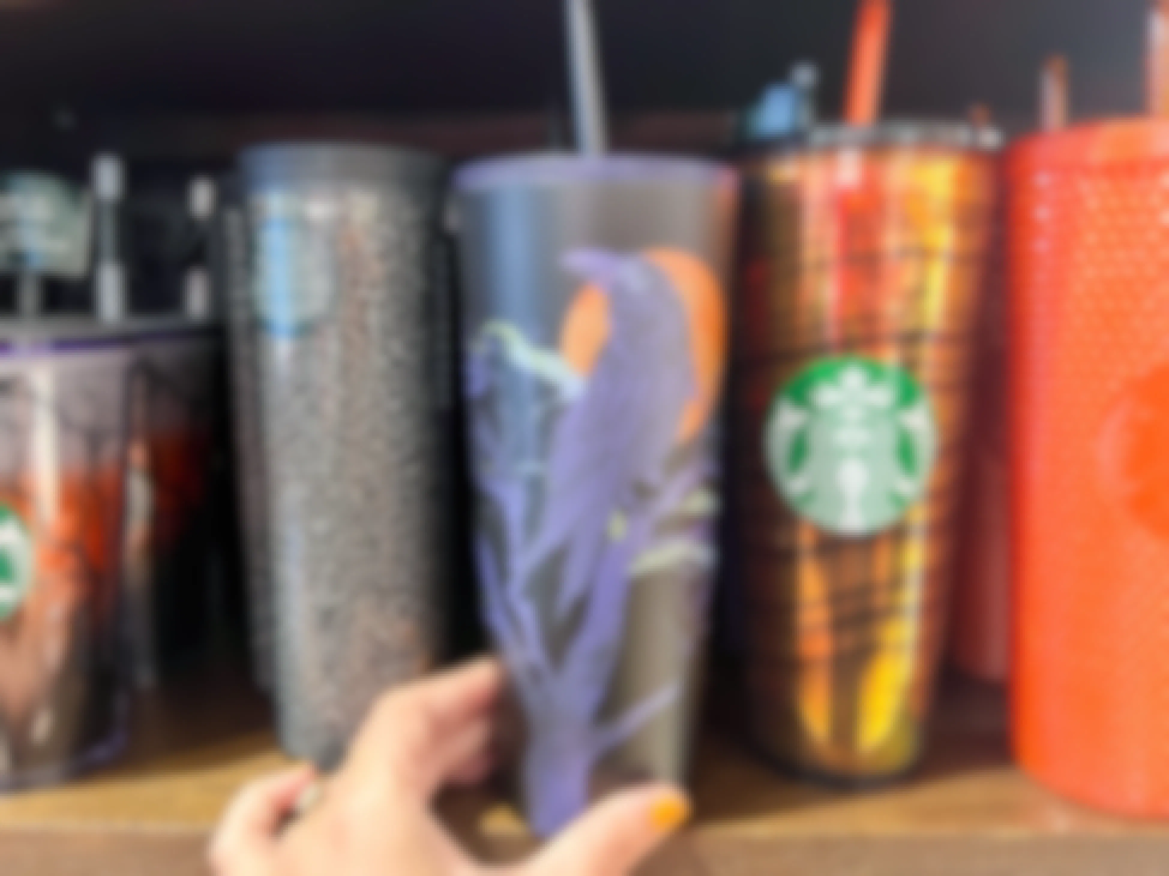 A Raven Starbucks cup on a shelf in Starbucks.