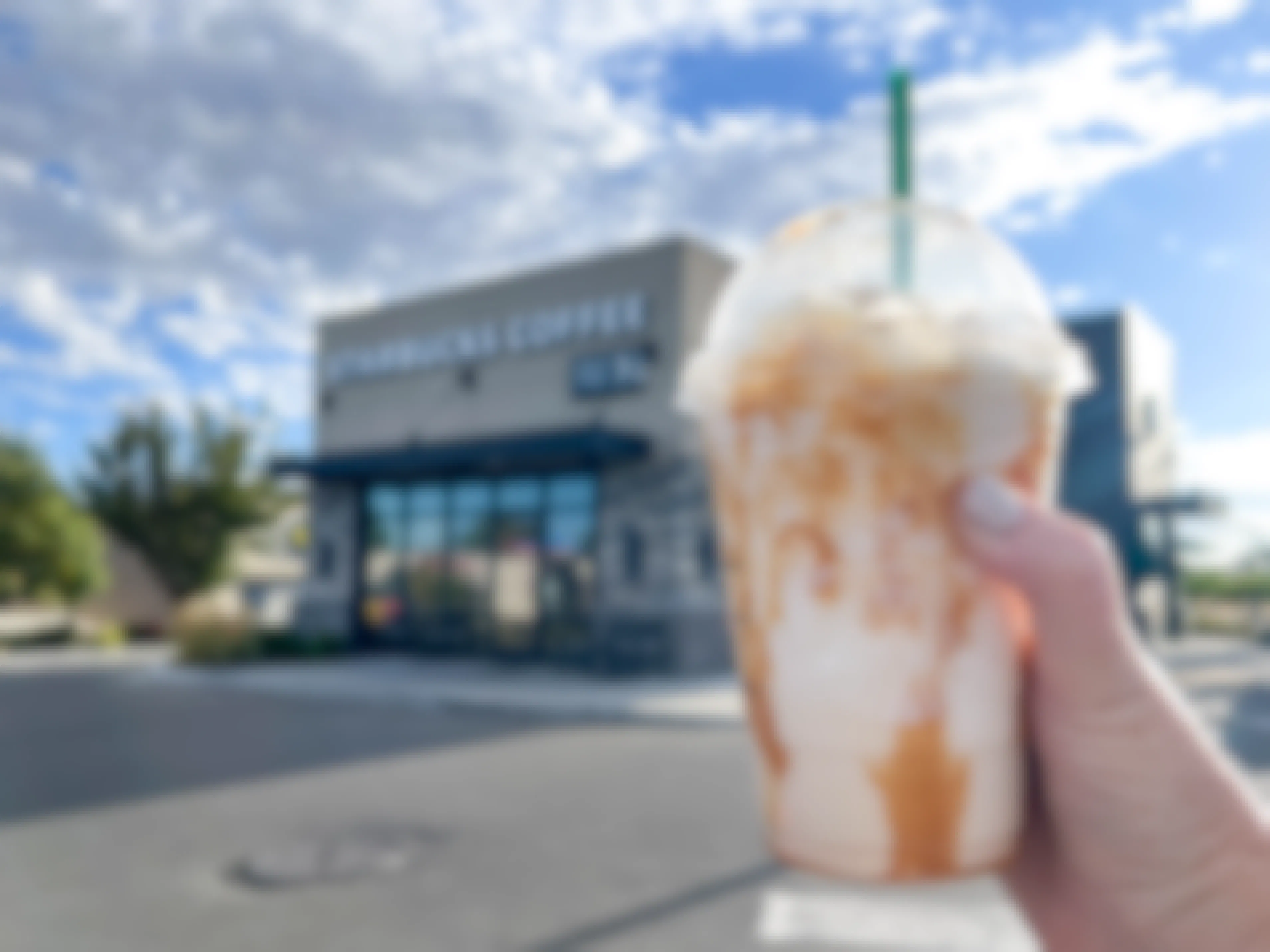 a starbucks frappuccino being held outside starbucks