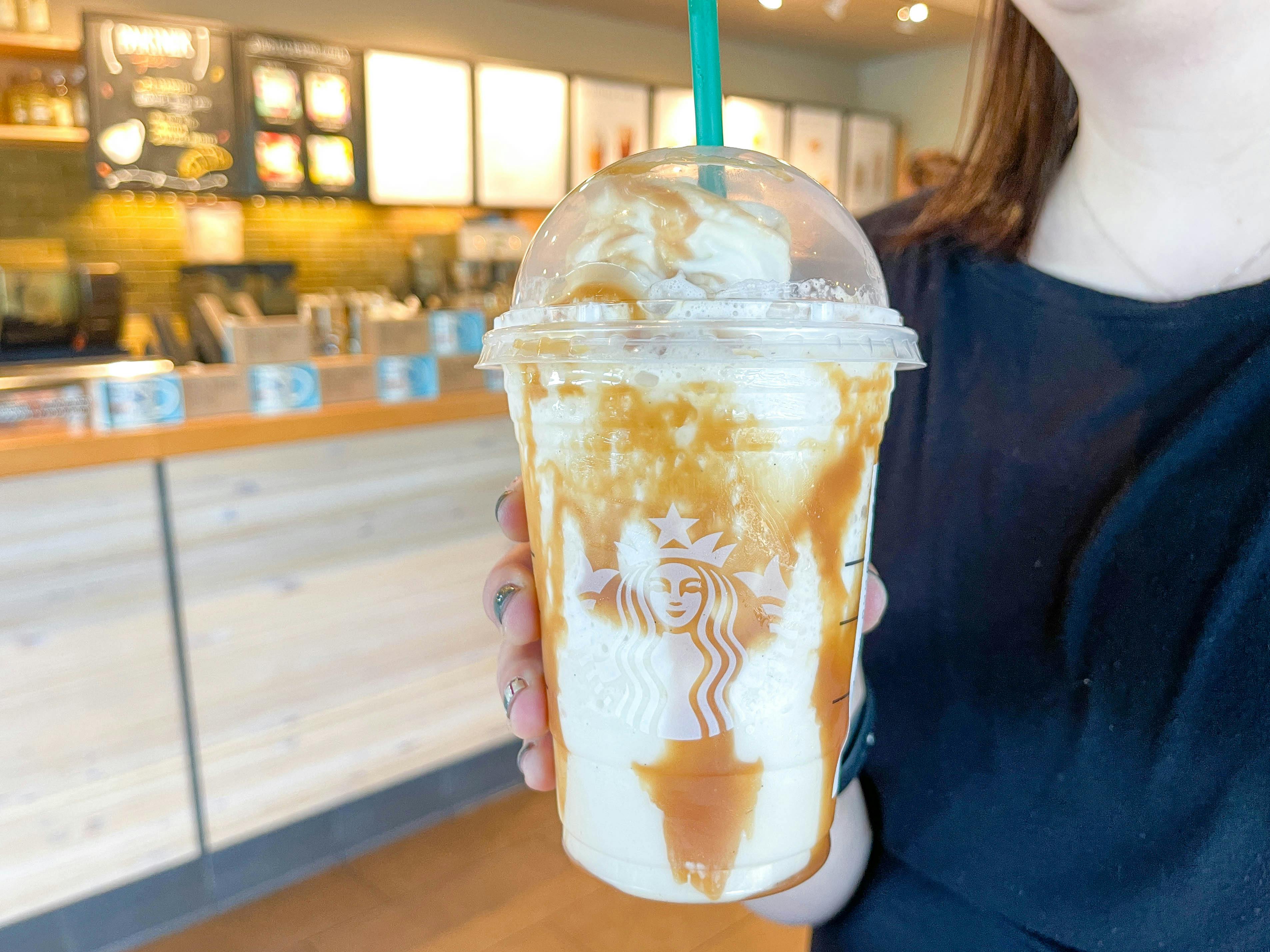 a starbucks frappuccino being held in starbucks 