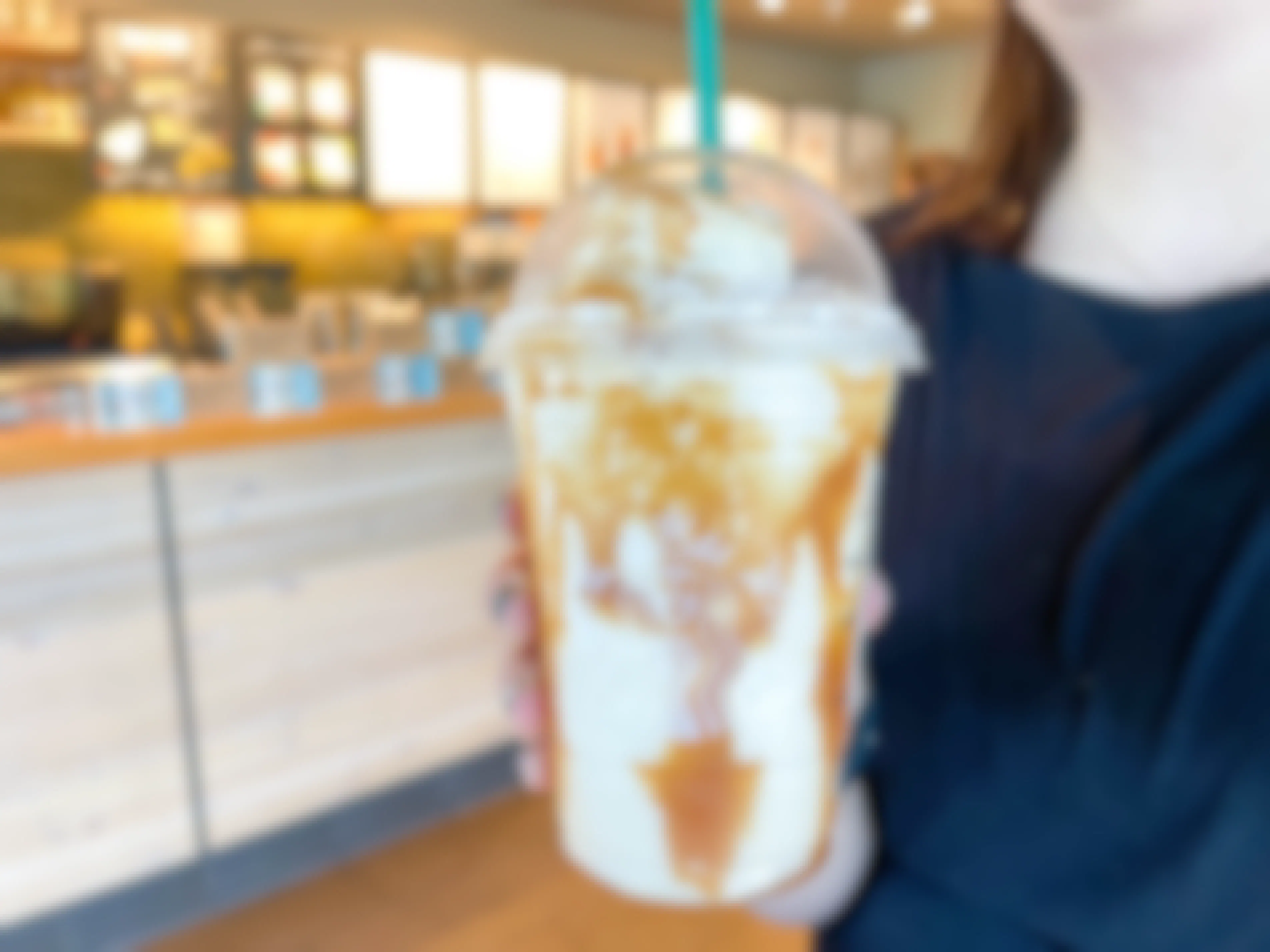a starbucks frappuccino being held in starbucks 