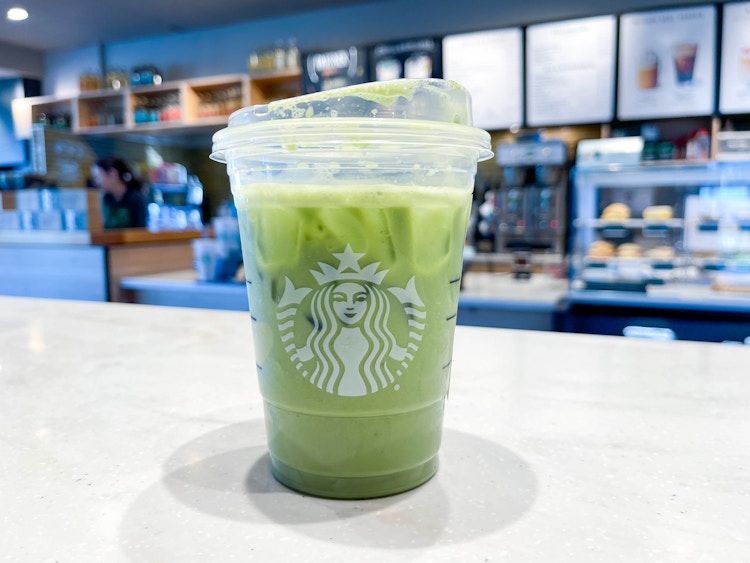 a starbucks drink being grabbed in starbucks