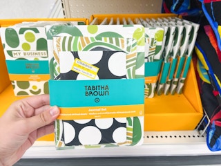 hand holding set of notebooks