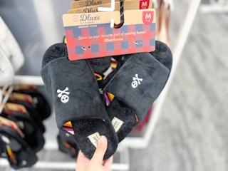hand holding dearfoams skull halloween slippers at target