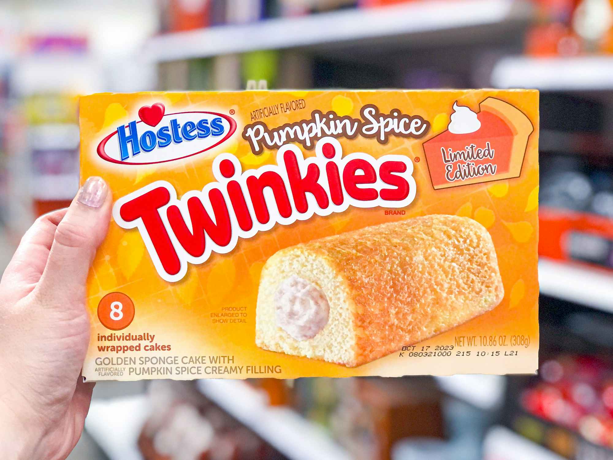 someone holding up a box of Hostess pumpkin spice twinkies