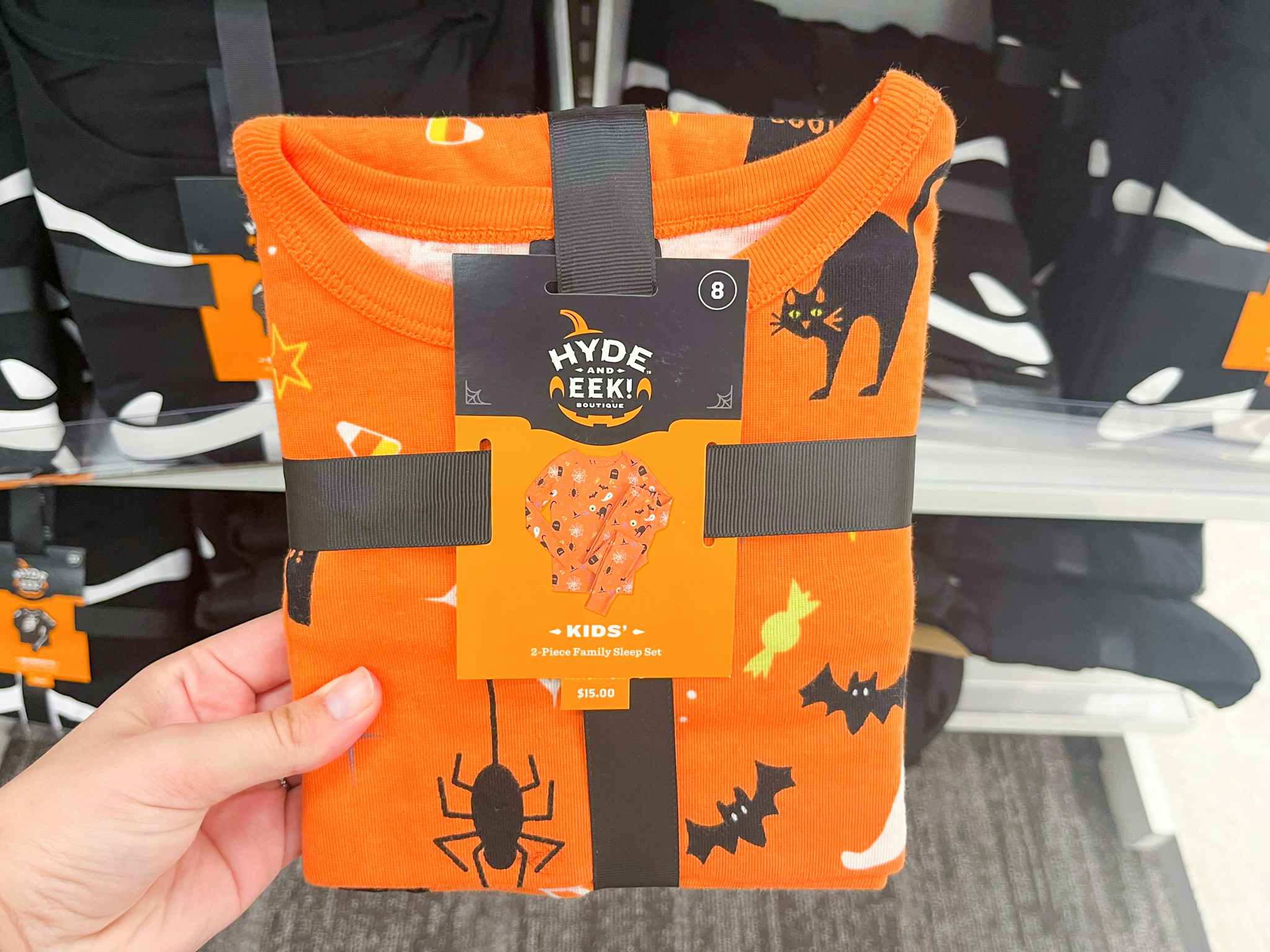 hand holding hyde and eek kids halloween pajamas at target