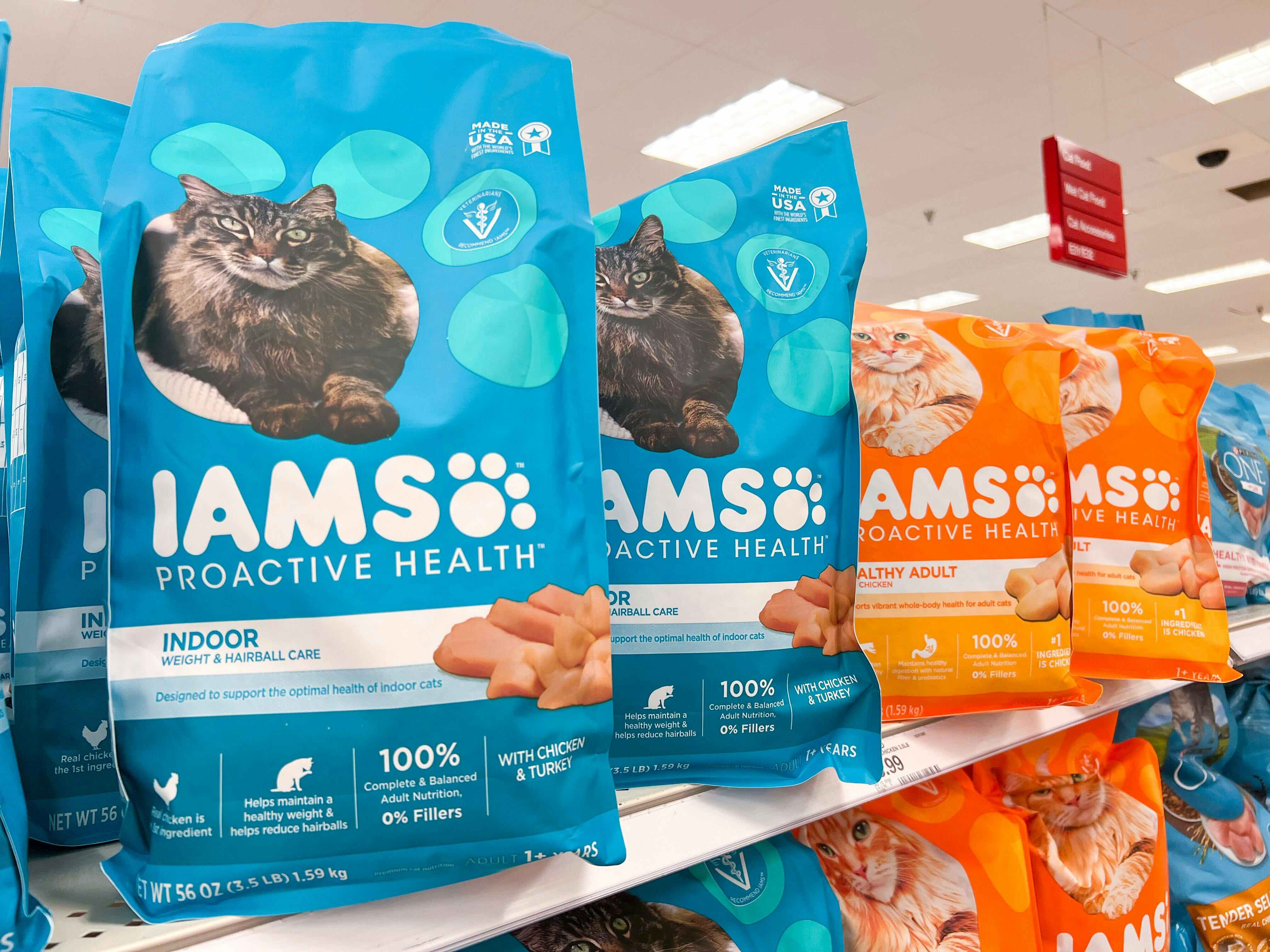 bags of iams cat food on a store shelf