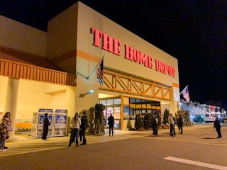 People standing outside of a Home Depot store.