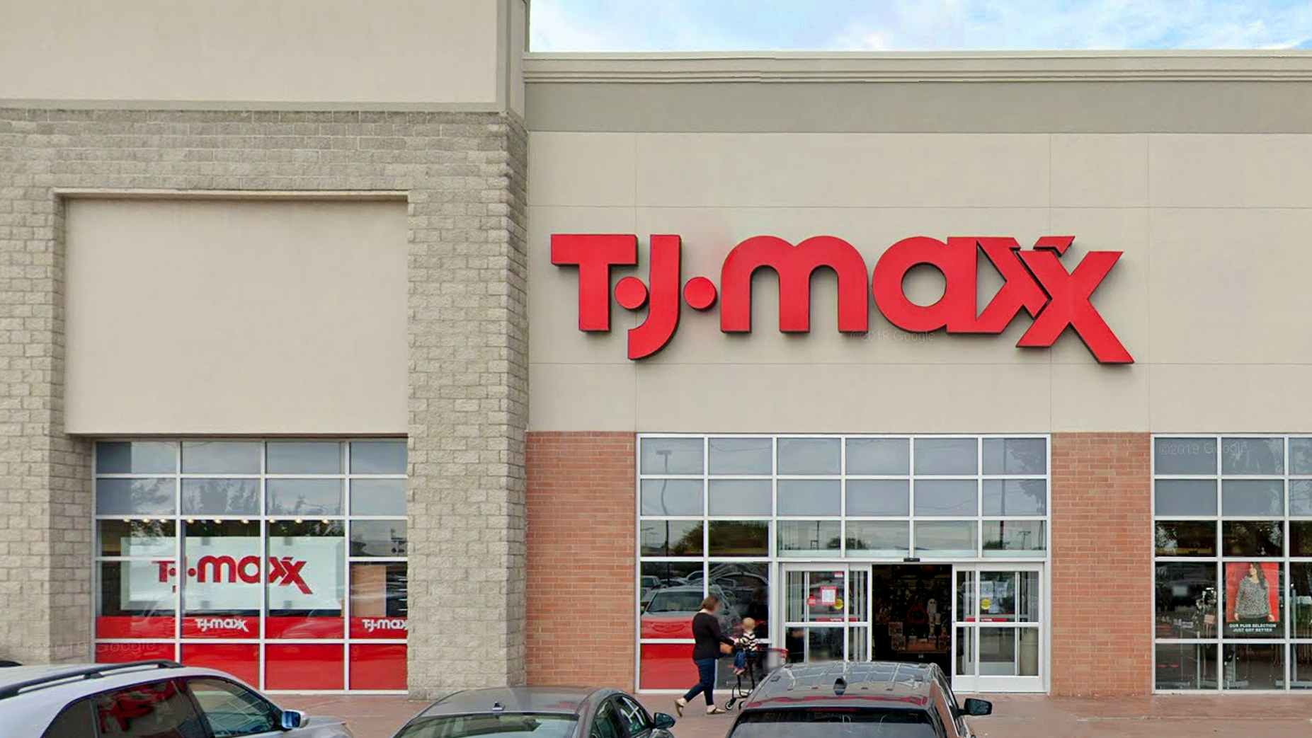 woman pushing stroller into tj maxx store