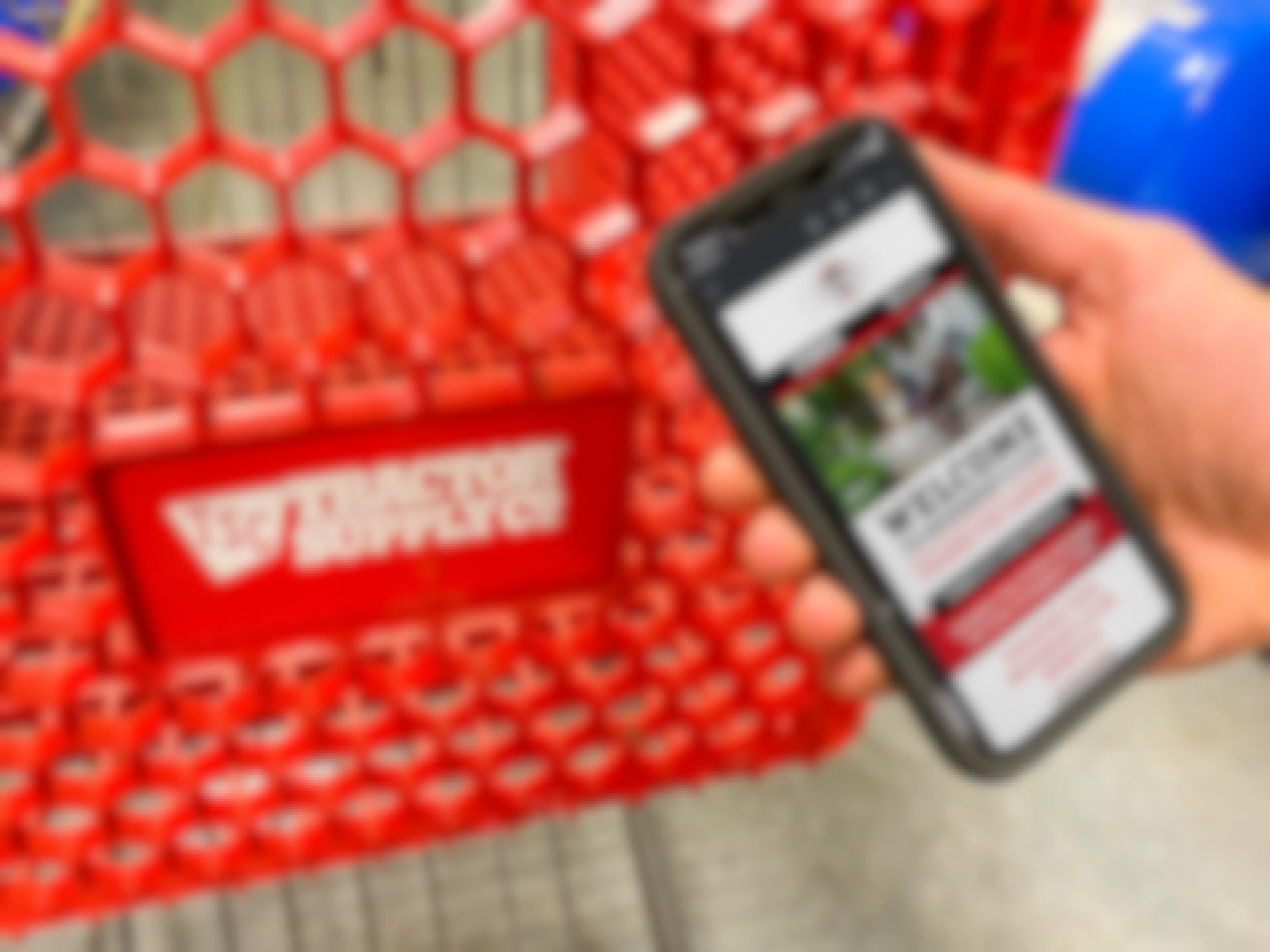 A person holding their phone displaying a welcome email from the TSC Neighbor's Club next to a Tractor Supply shopping cart.