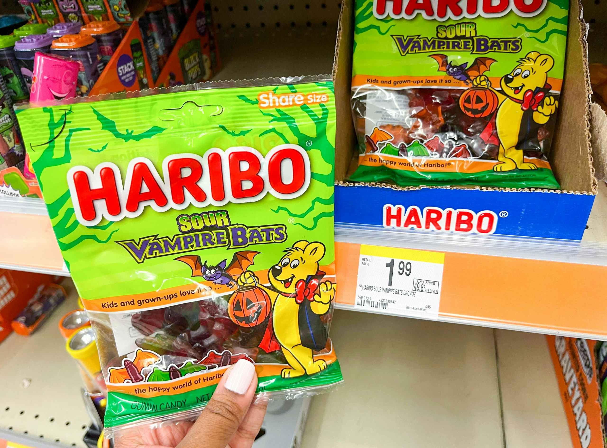 hand holding pack of Haribo sour vampire bats candy next to price tag
