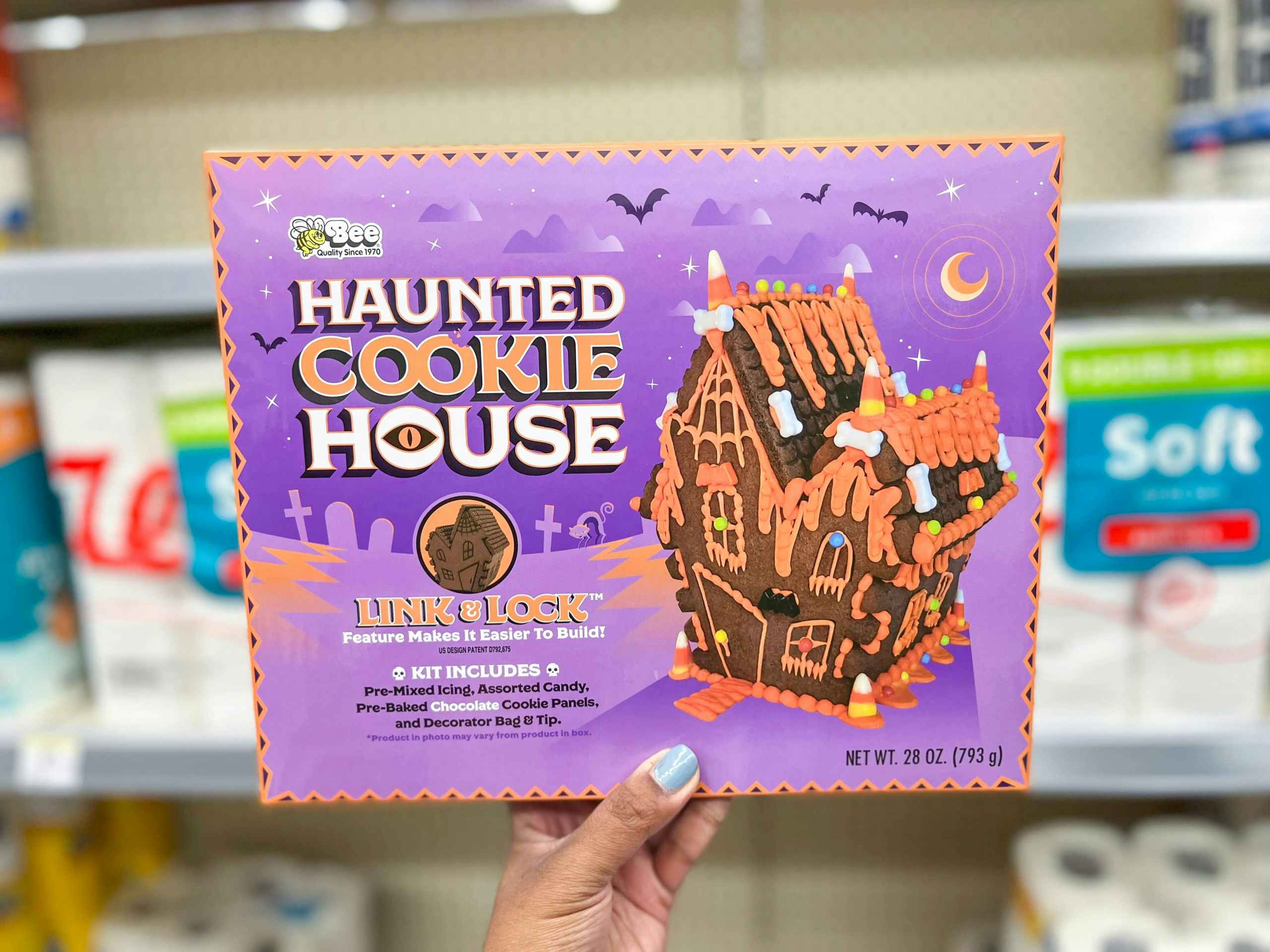hand holding a Haunted Cookie House box in aisle