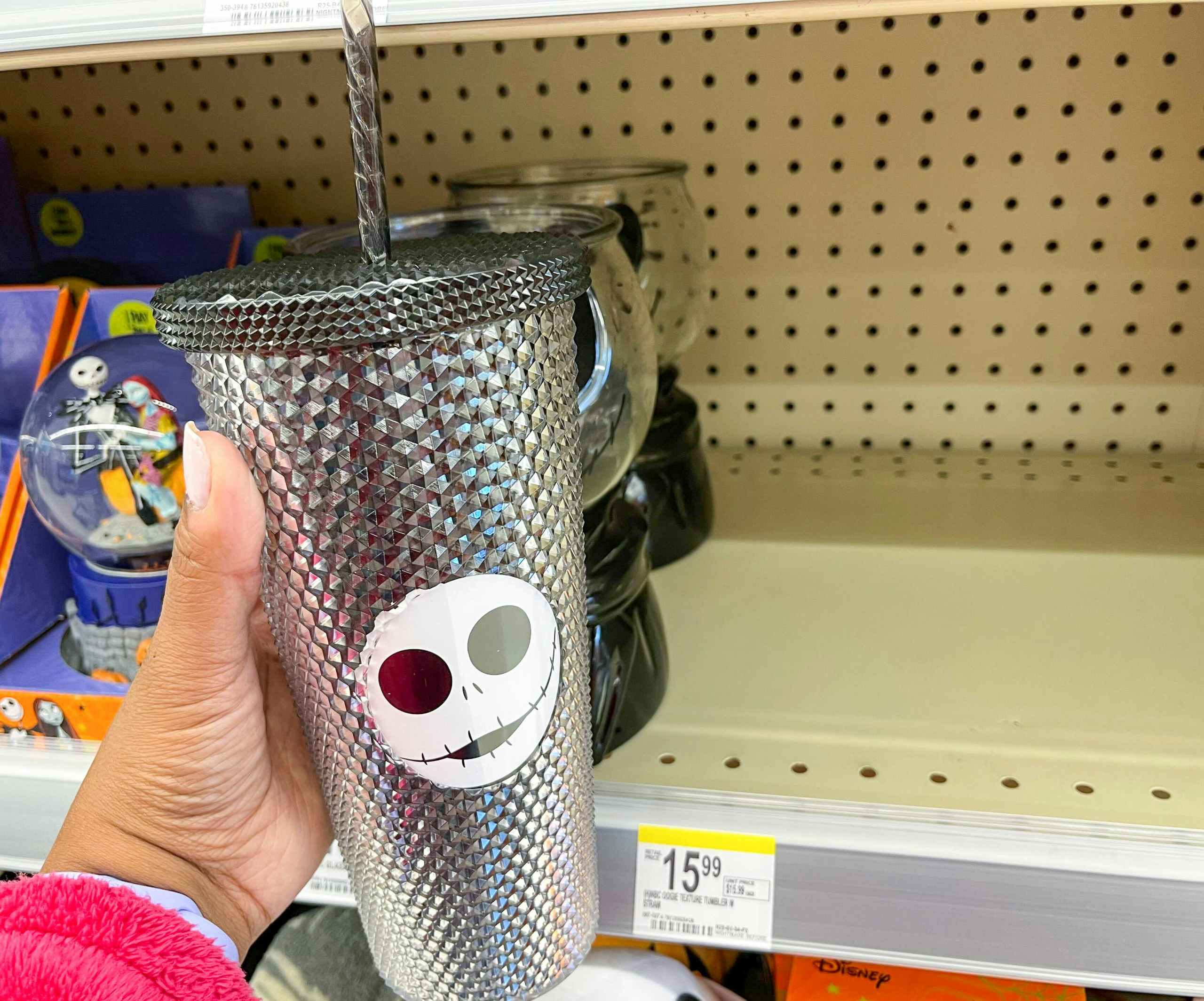 hand holding Nightmare before Christmas studded tumbler next to price tag