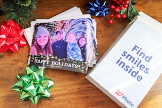 photo card and envelopes next to a algreens box on a desk