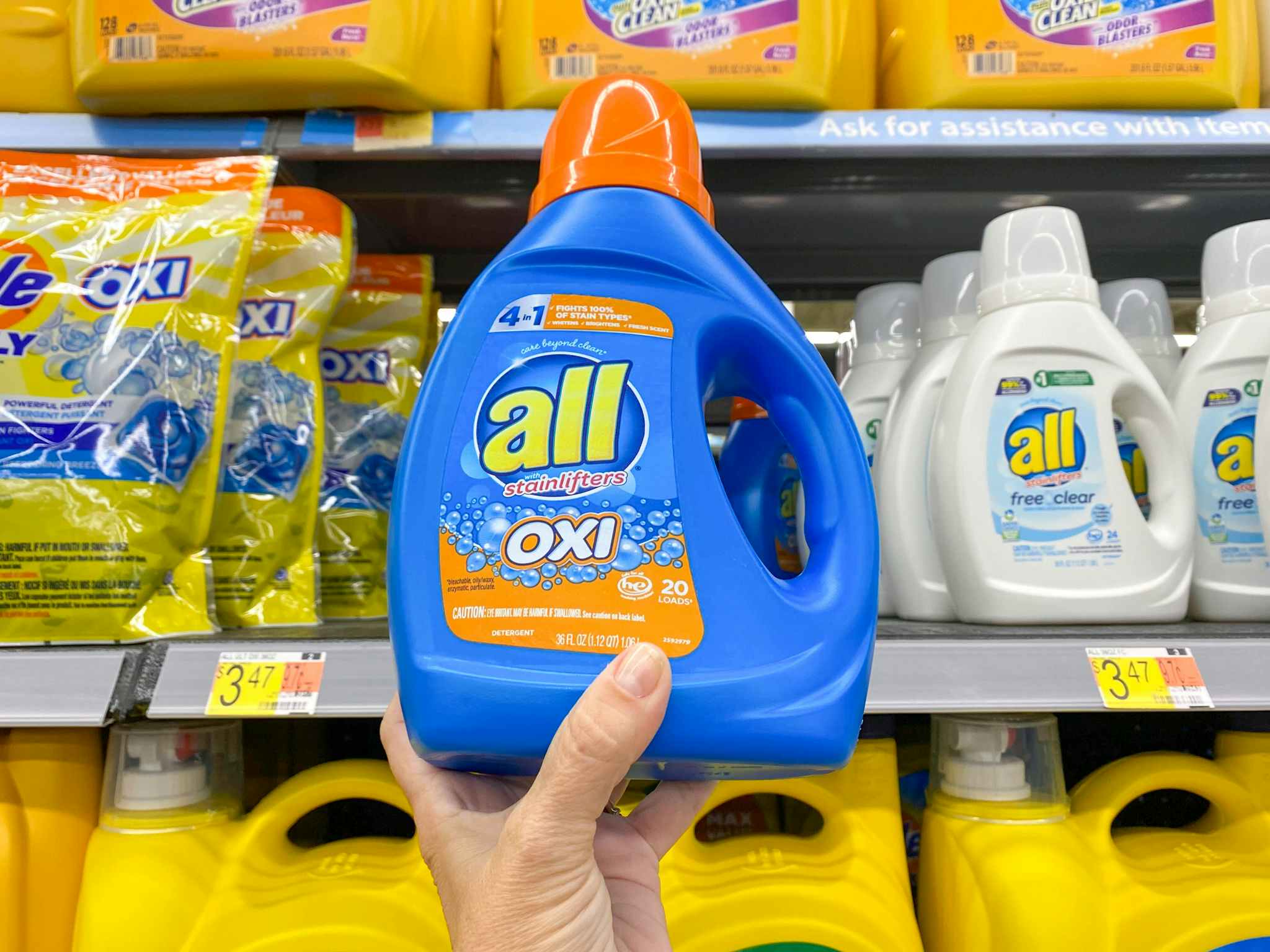 hand holding all with oxi laundry detergent at walmart