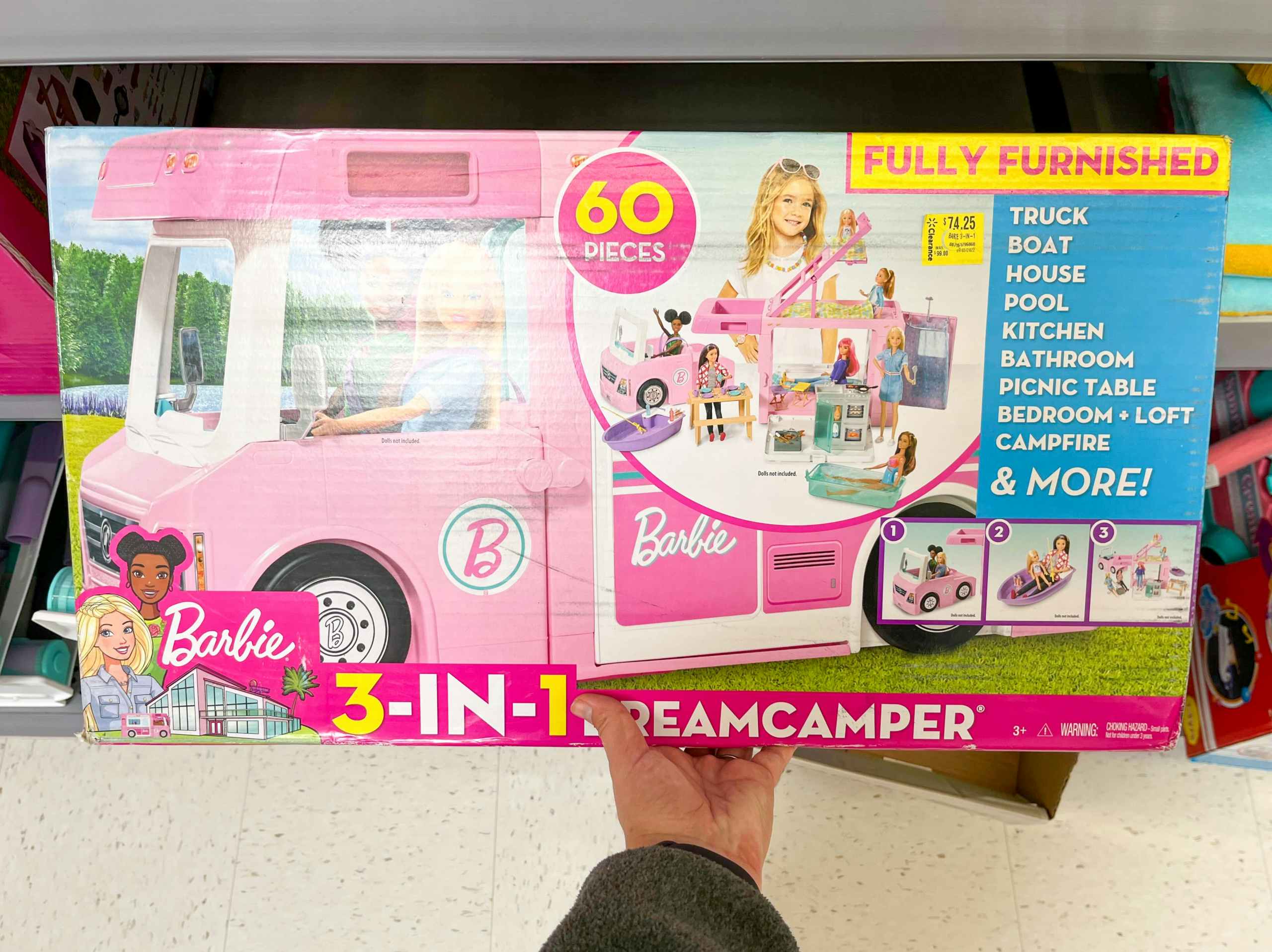 hand holding Barbie 3-in-1 camper