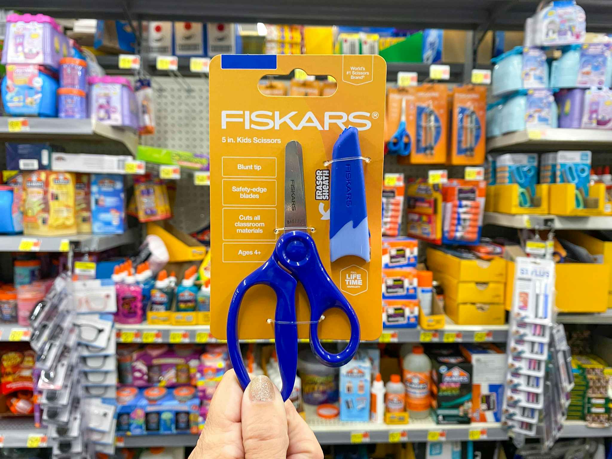 hand holding fiskars kids safety scissors