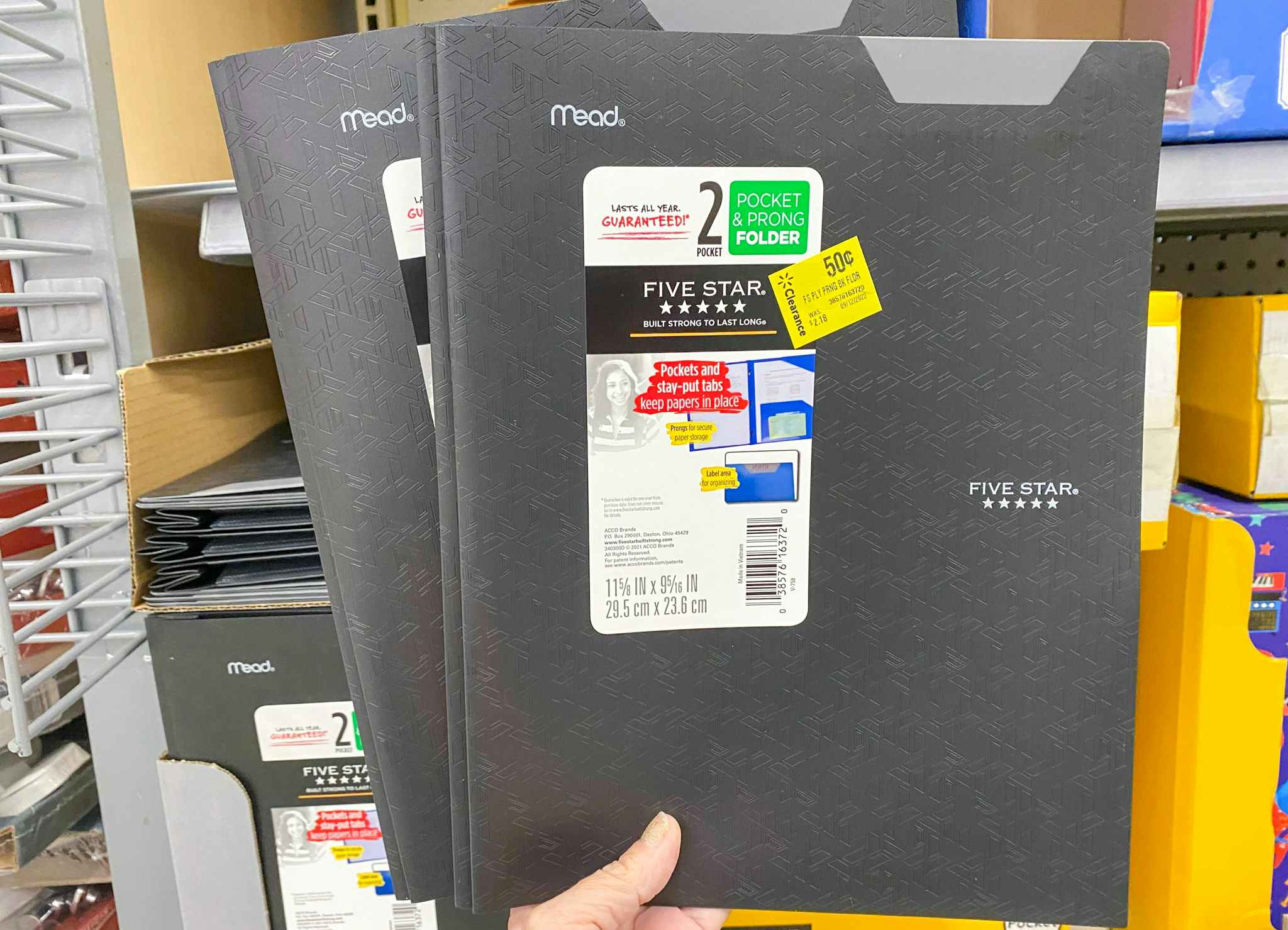 hand holding five star folders at walmart