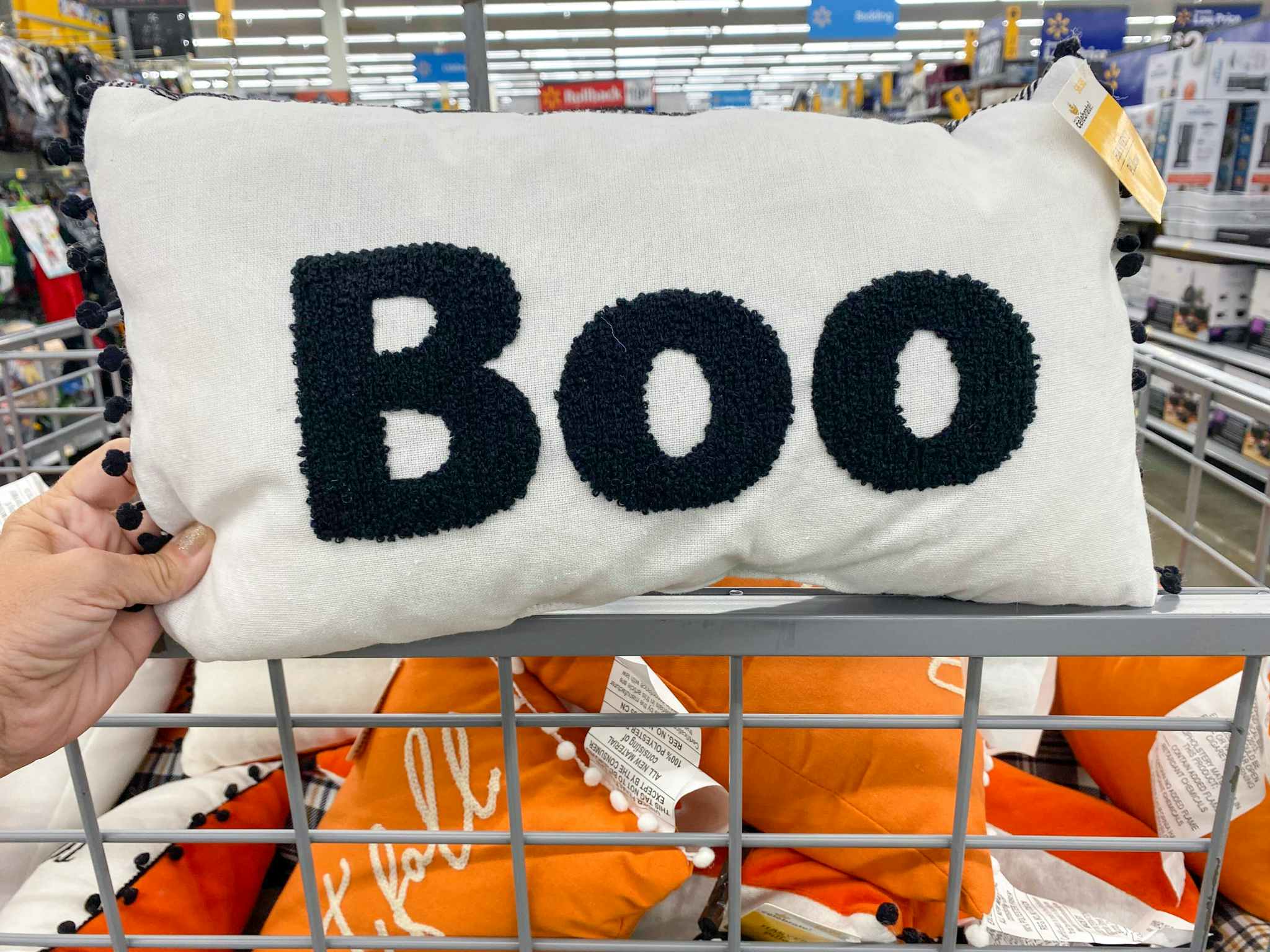 hand holding halloween pillow boo at walmart