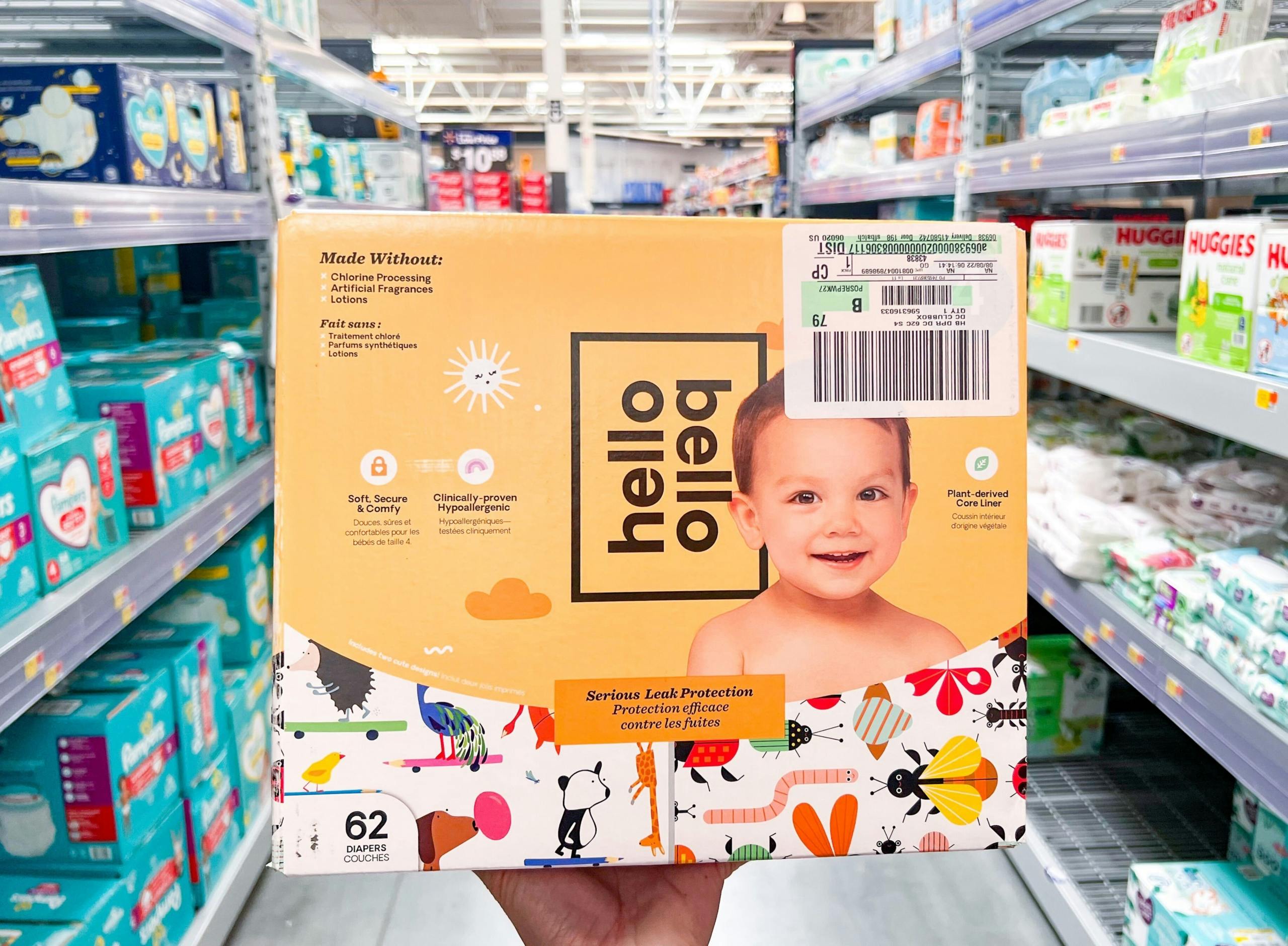 hand holding up a box of Hello Bello diapers in a Walmart aisle