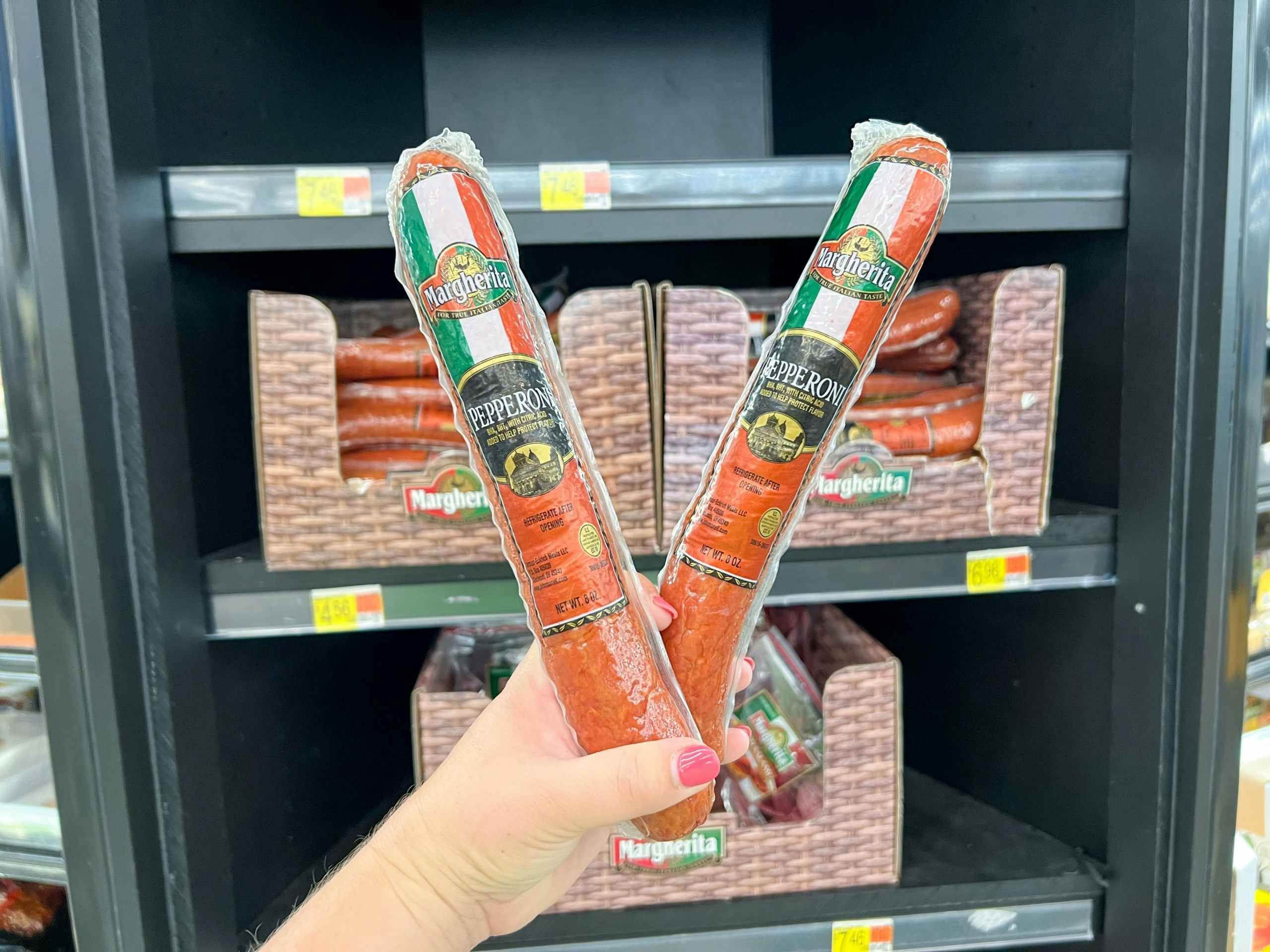 hand holding margherita pepperoni logs at walmart