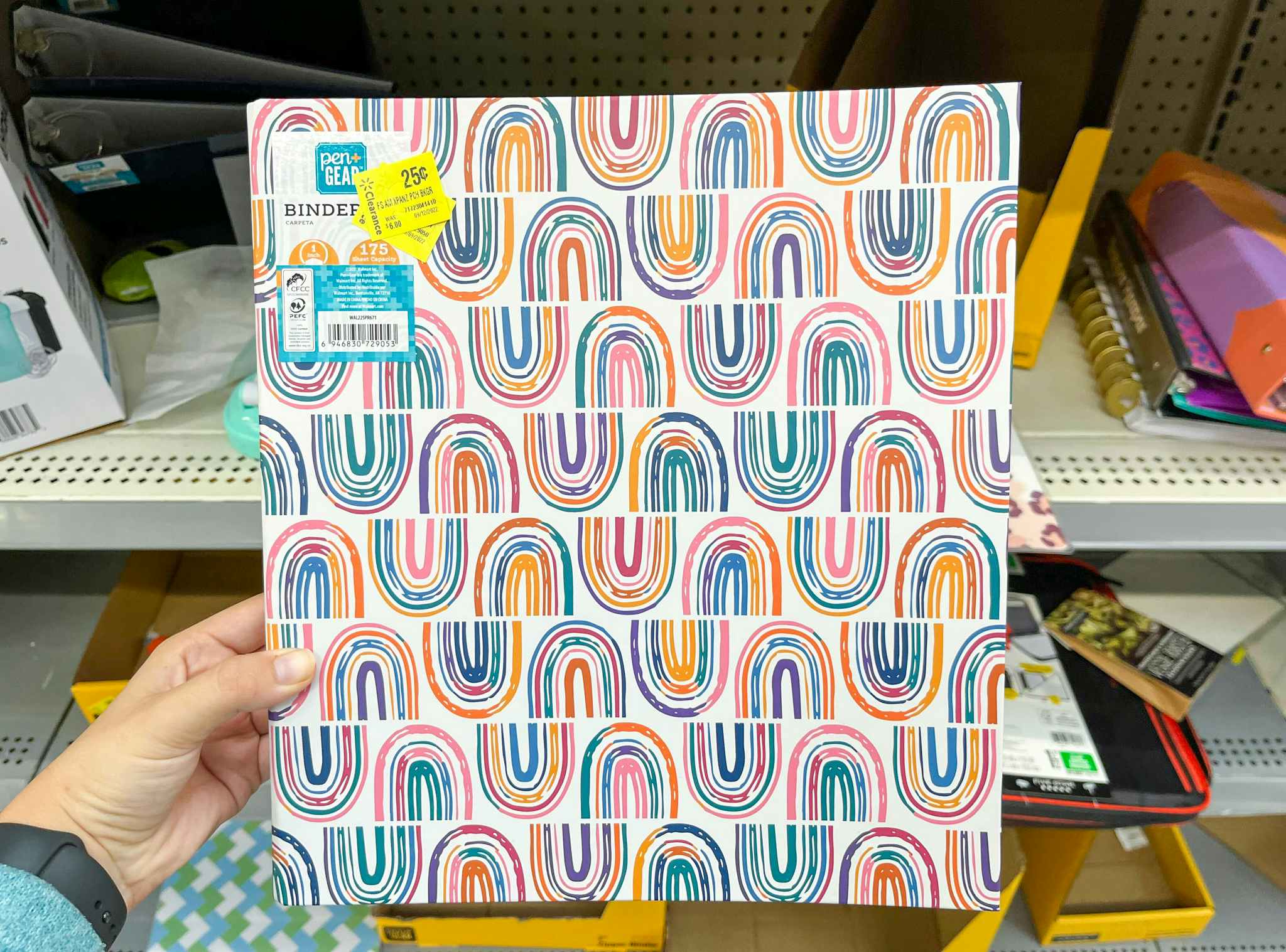 hand holding pen gear rainbow binder at walmart