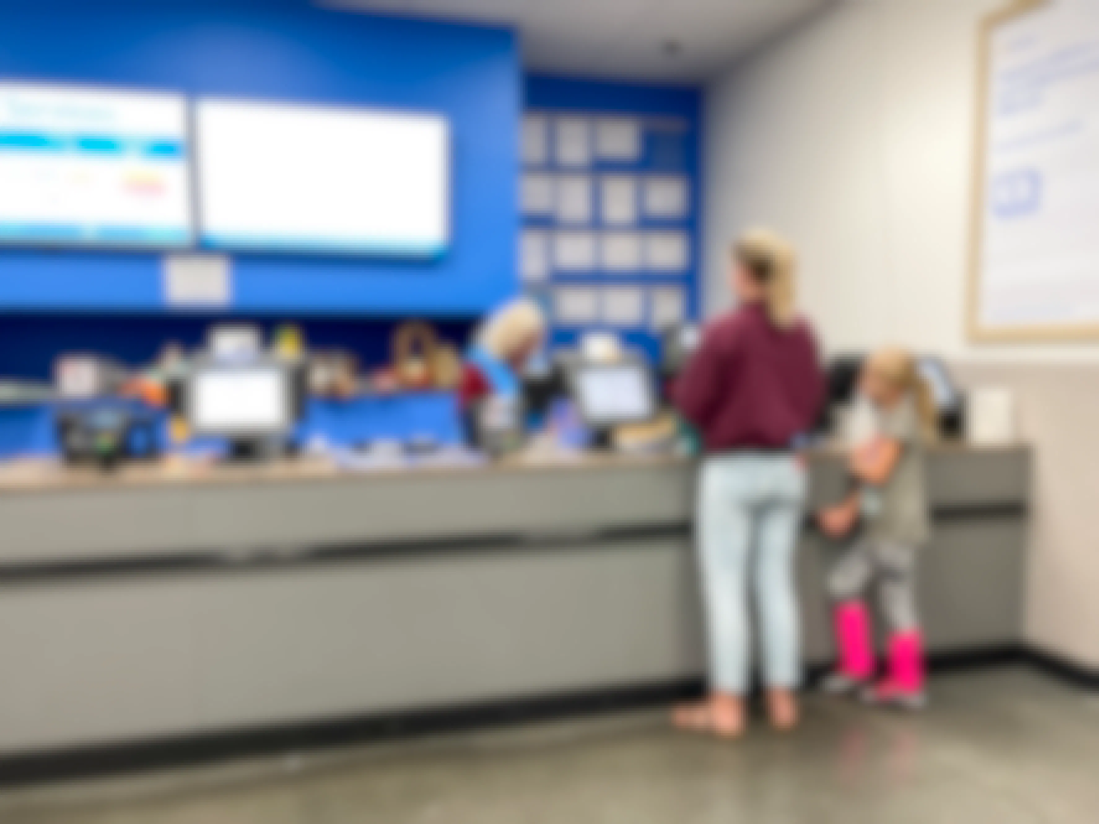 A parent and child standing together at the Walmart customer service desk