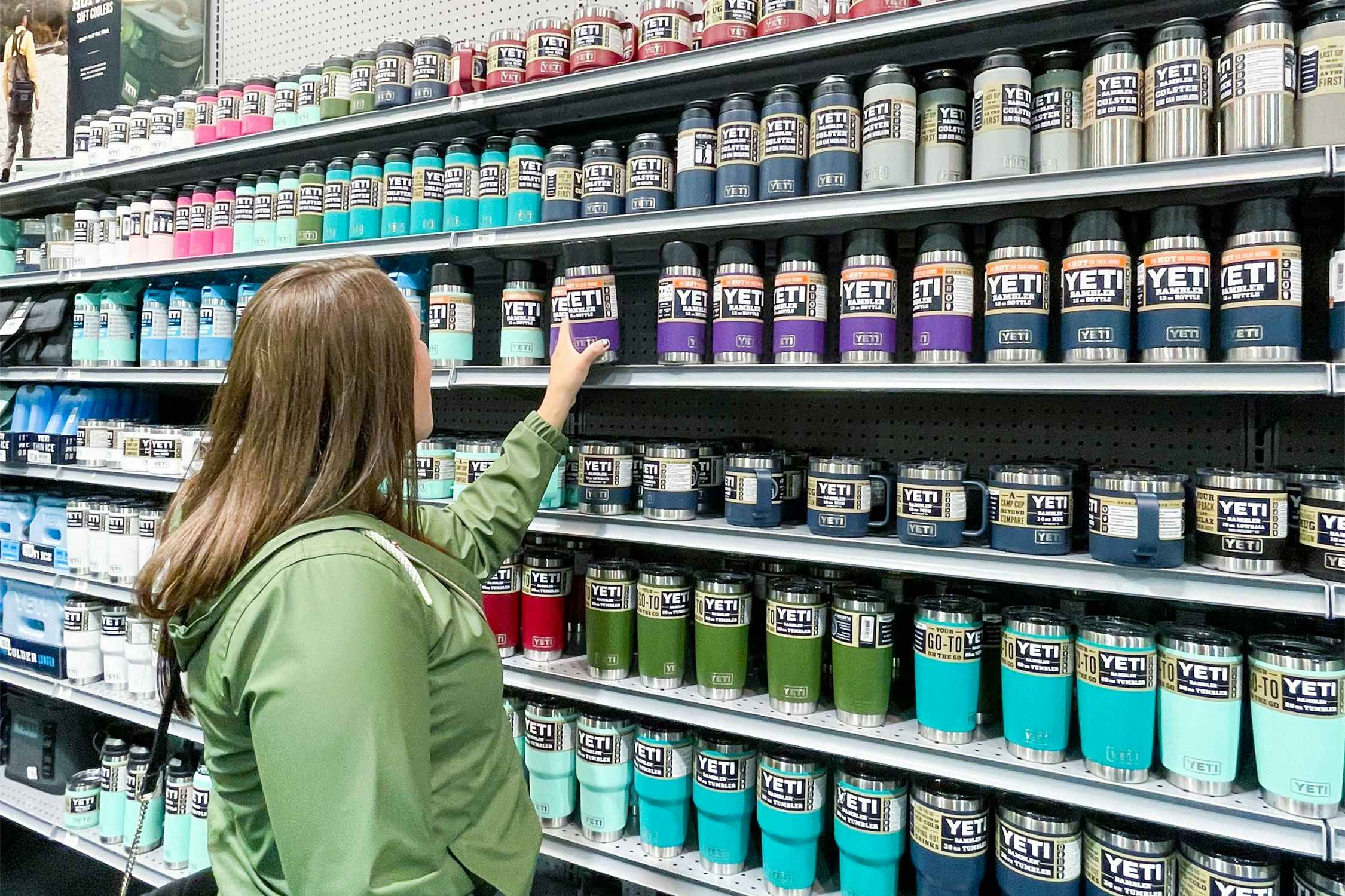 woman looking at yeti tumblers on shelves