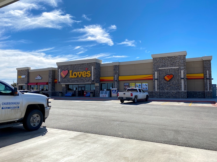 The front of a Love's travel center with a truck parked in front.