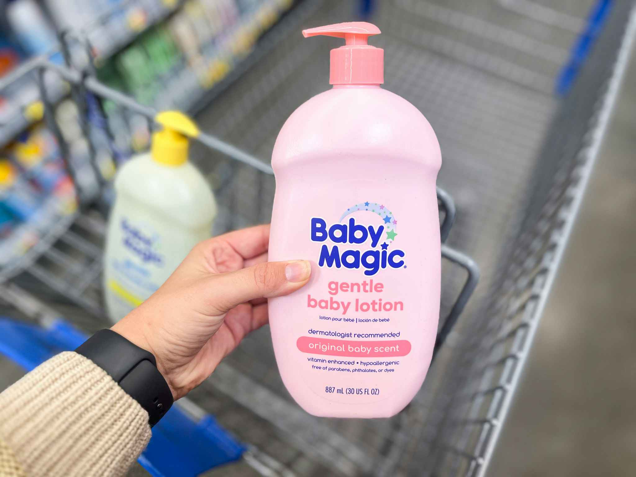 holding up Baby Magic lotion at Walmart