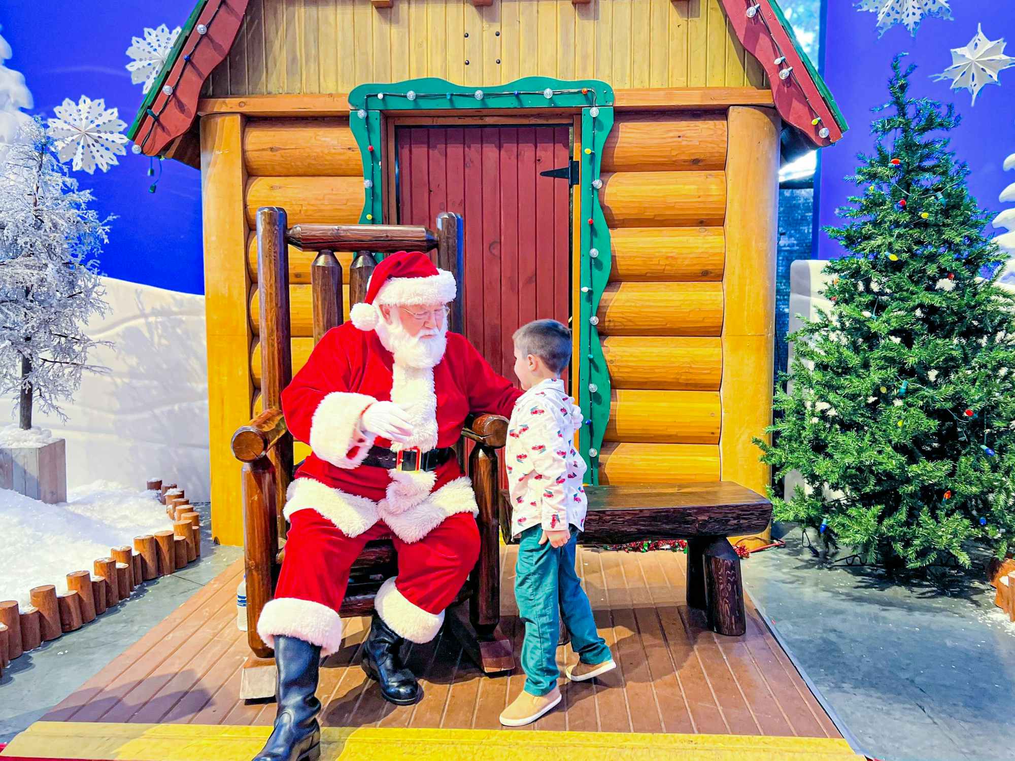 a child next to Santa at Bass Pro Shops