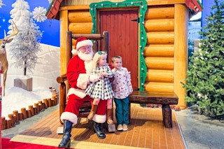 two kids next to Santa at Bass Pro Shops