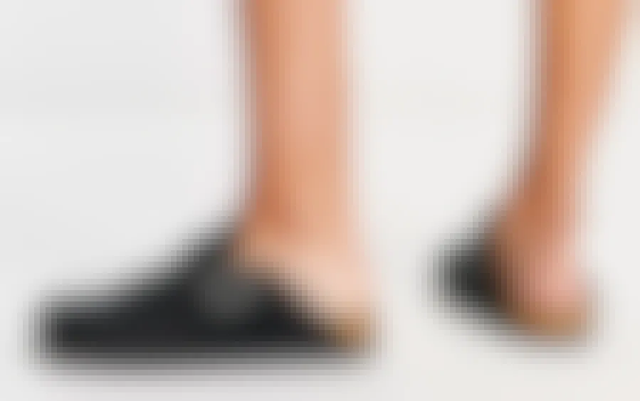 A person wearing Monki Faux Suede Clogs on a neutral background.
