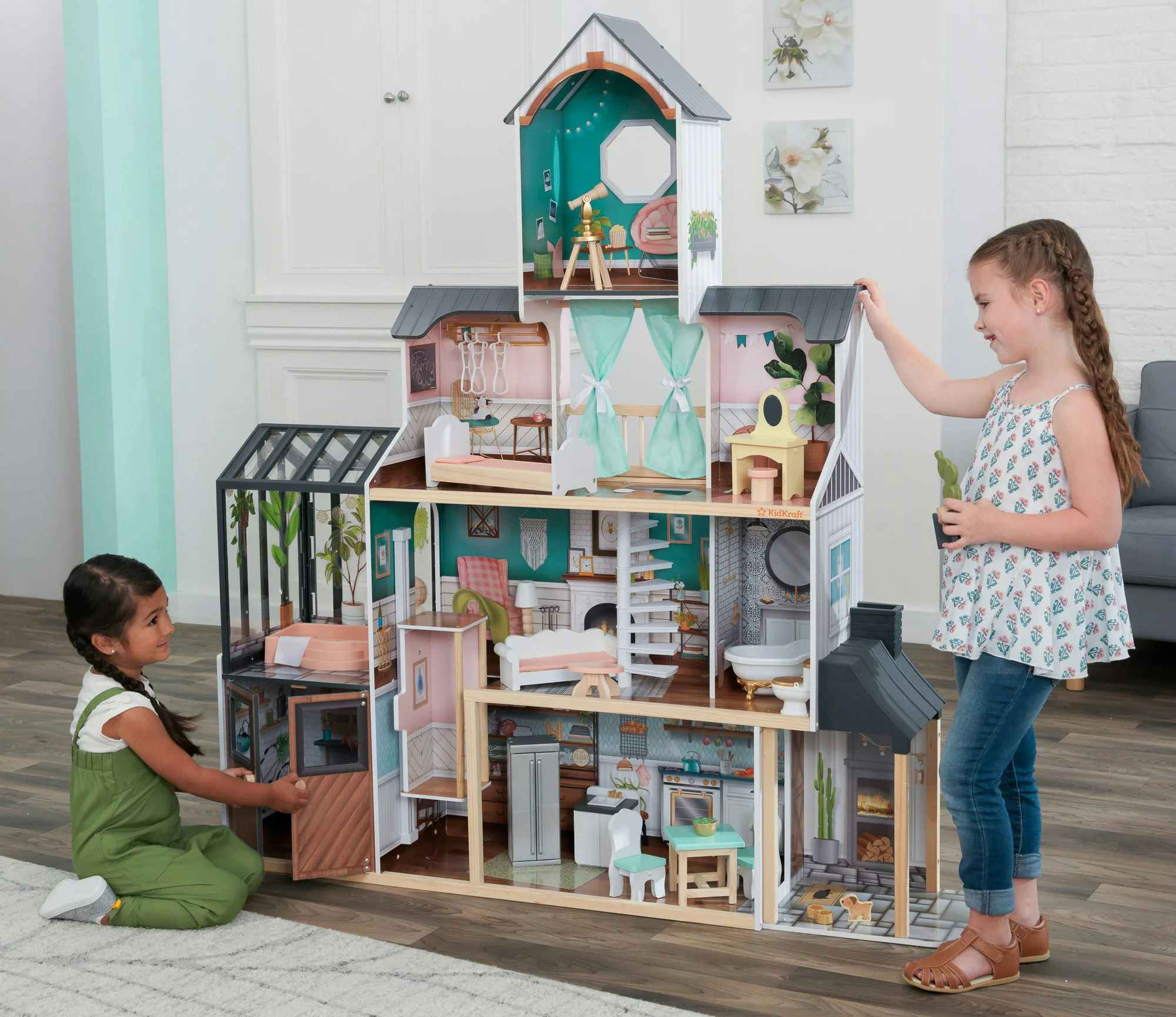 Children playing with a KidKraft Celeste Mansion Dollhouse