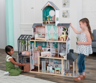 Children playing with a KidKraft Celeste Mansion Dollhouse