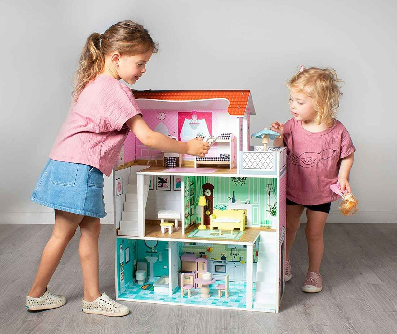 Children playing with a Milliard Doll House