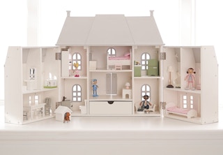 A Pottery Barn Kids Barrington Dollhouse by a window