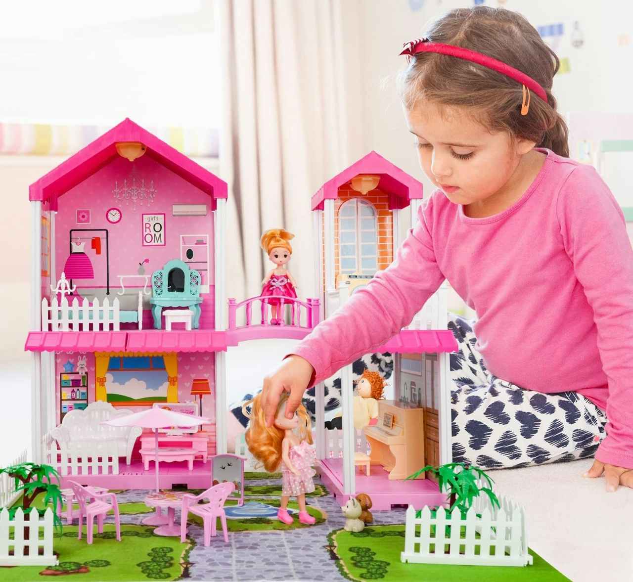 A child playing with a Toy Life Pink Dollhouse