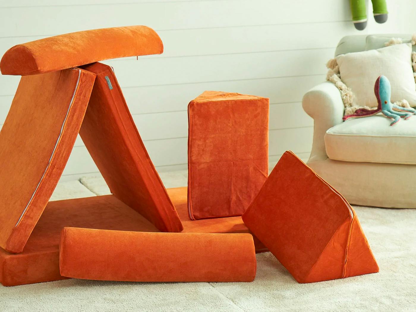 Pieces of a Brentwood Home Play Couch Sofa for Kids stacked in a living room
