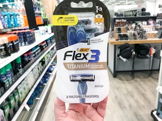 hand holding bic flex 3 razors in aisle