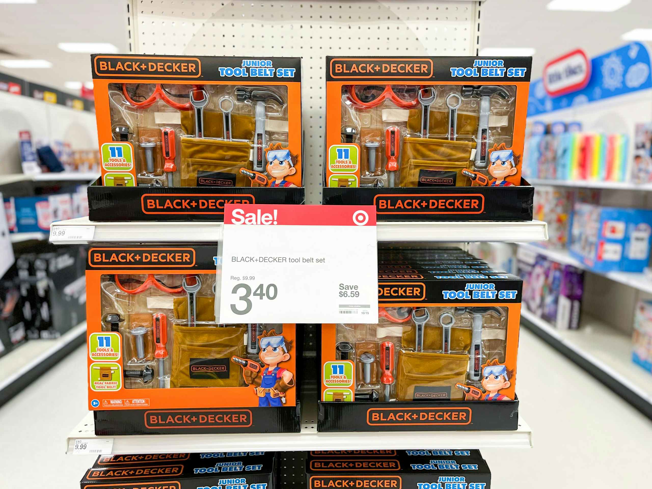 toy tool sets on shelf with sale sign