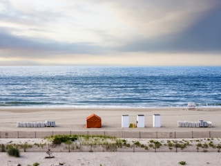 beach and ocean with piled chairs 