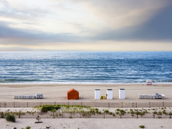 beach and ocean with piled chairs 