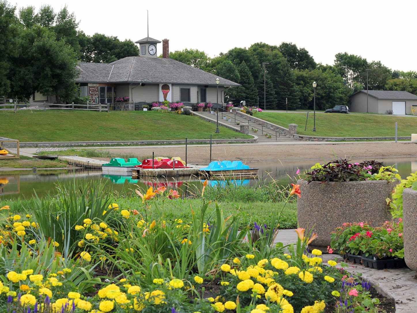 park with pond, shelter, flowers, and paddleboats in huron, south dakota